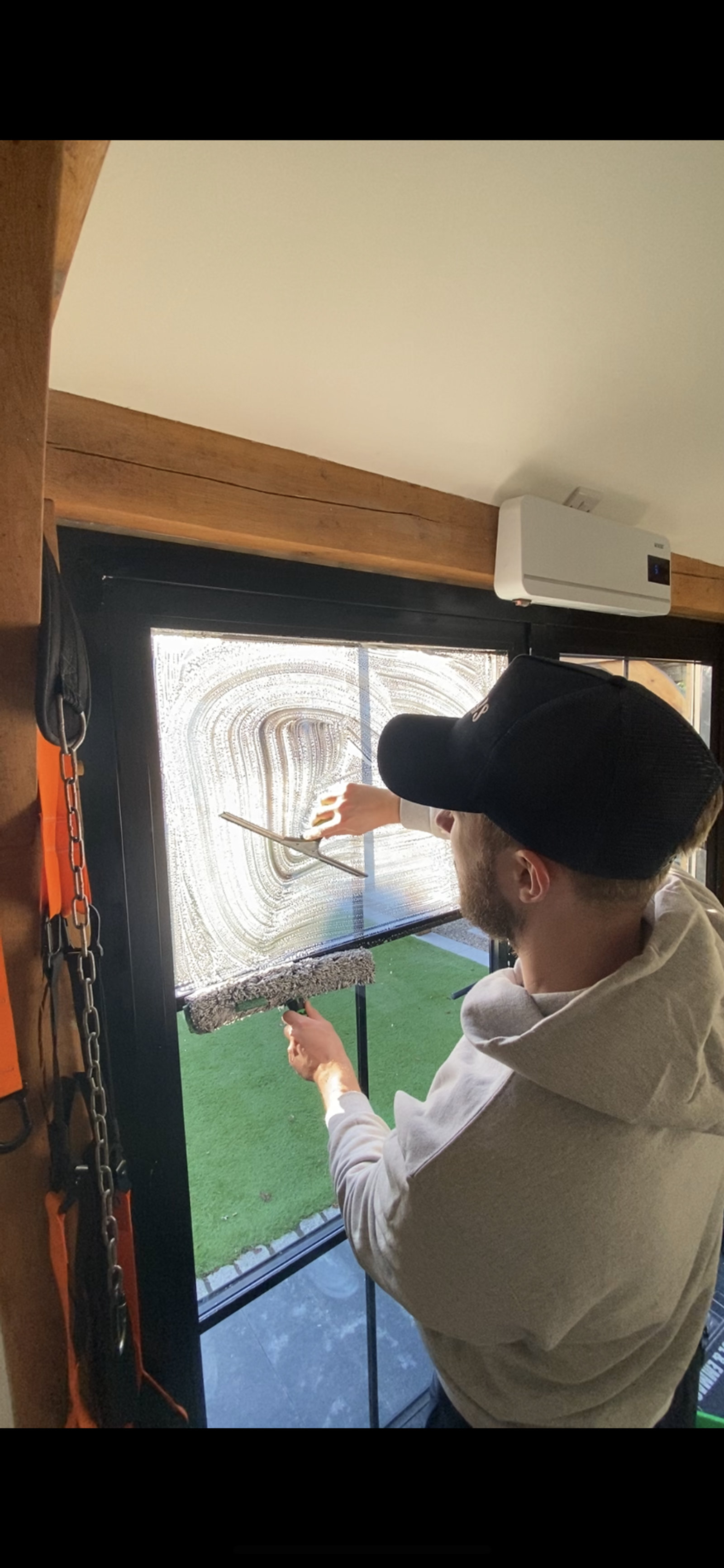 Cleaning an interior window pane with a squeegee