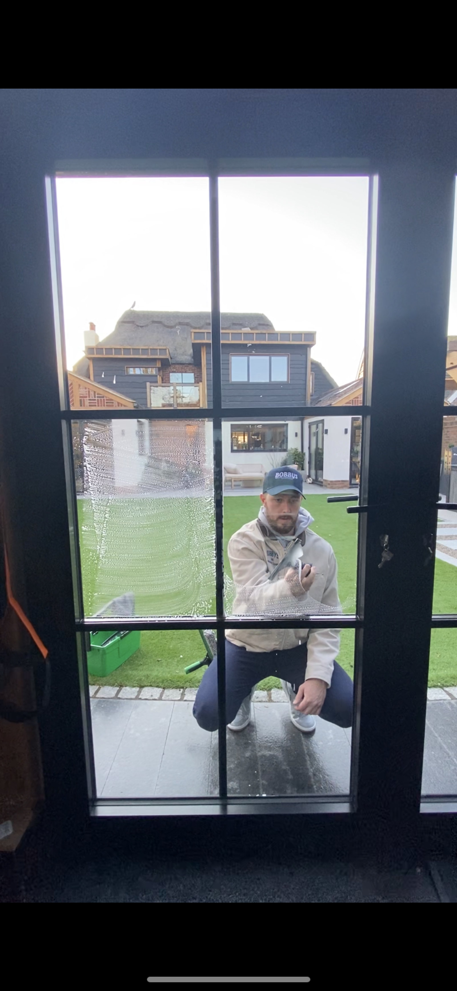 Cleaning Crittall-style doors at a thatched cottage